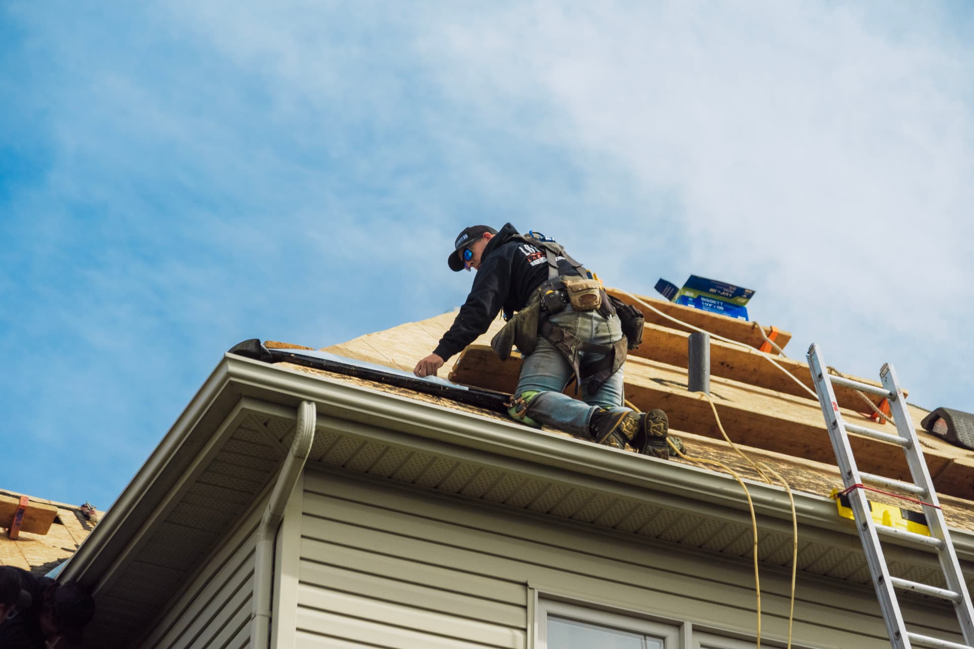 Roofers replacing shingles on a Centerville, Ohio home